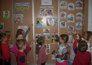 Smyki po zajęciach nt. Prawa Dziecka wskazują obrazki umocowane w różnych miejscach sali