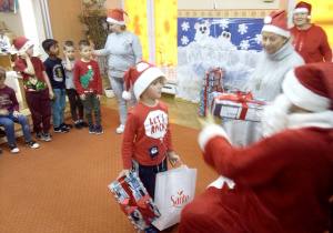 chłopczyk odbiera prezent od Św. Mikołaja