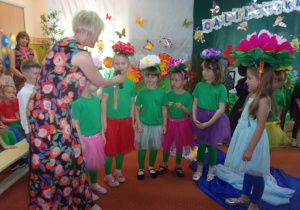 dzieci w przebraniach podczas bajki "Calineczka", nauczyciel trzymający mikrofon