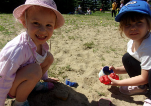 dwie dziewczynki bawiące się w piasku