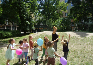 dzieci bawią się balonami w ogrodzie przedszkolnym