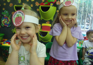 dwie dziewczynki z opaskami jabłek na głowie